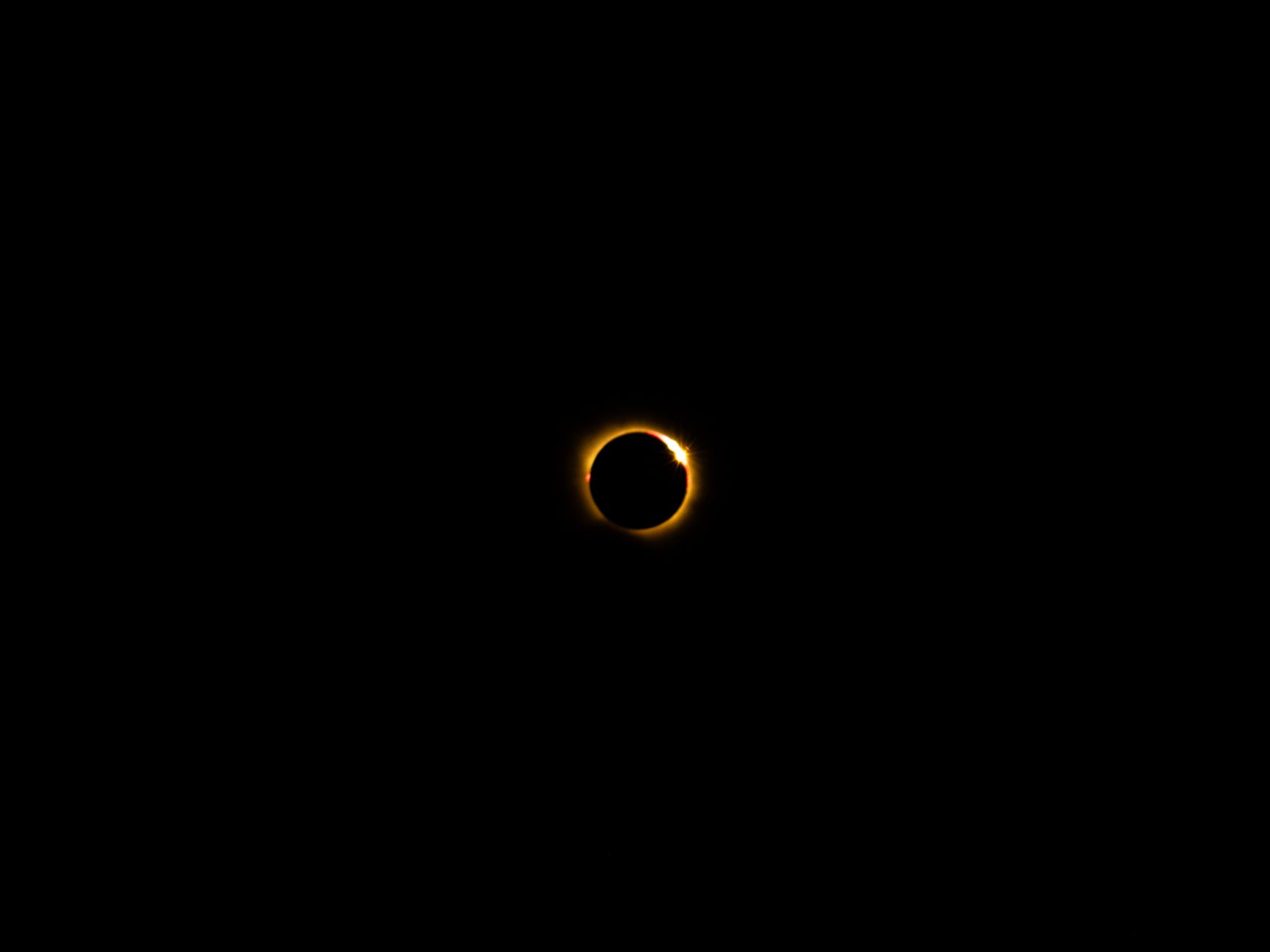 A mesmerizing view of a solar eclipse showcasing the glowing corona against a dark sky.